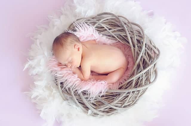 tiny infant in feather wreath